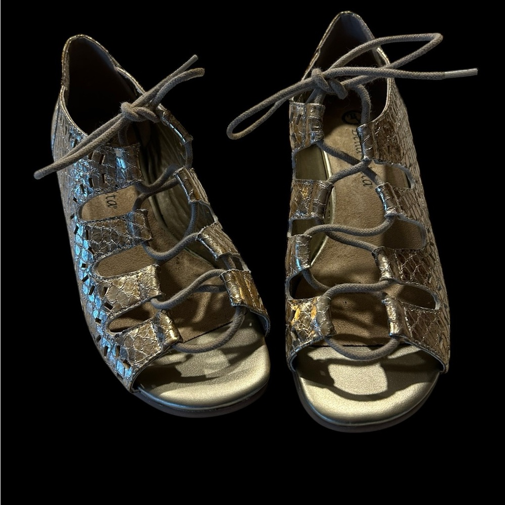 Striking Bella Vita gold shoes in a gladiator style
